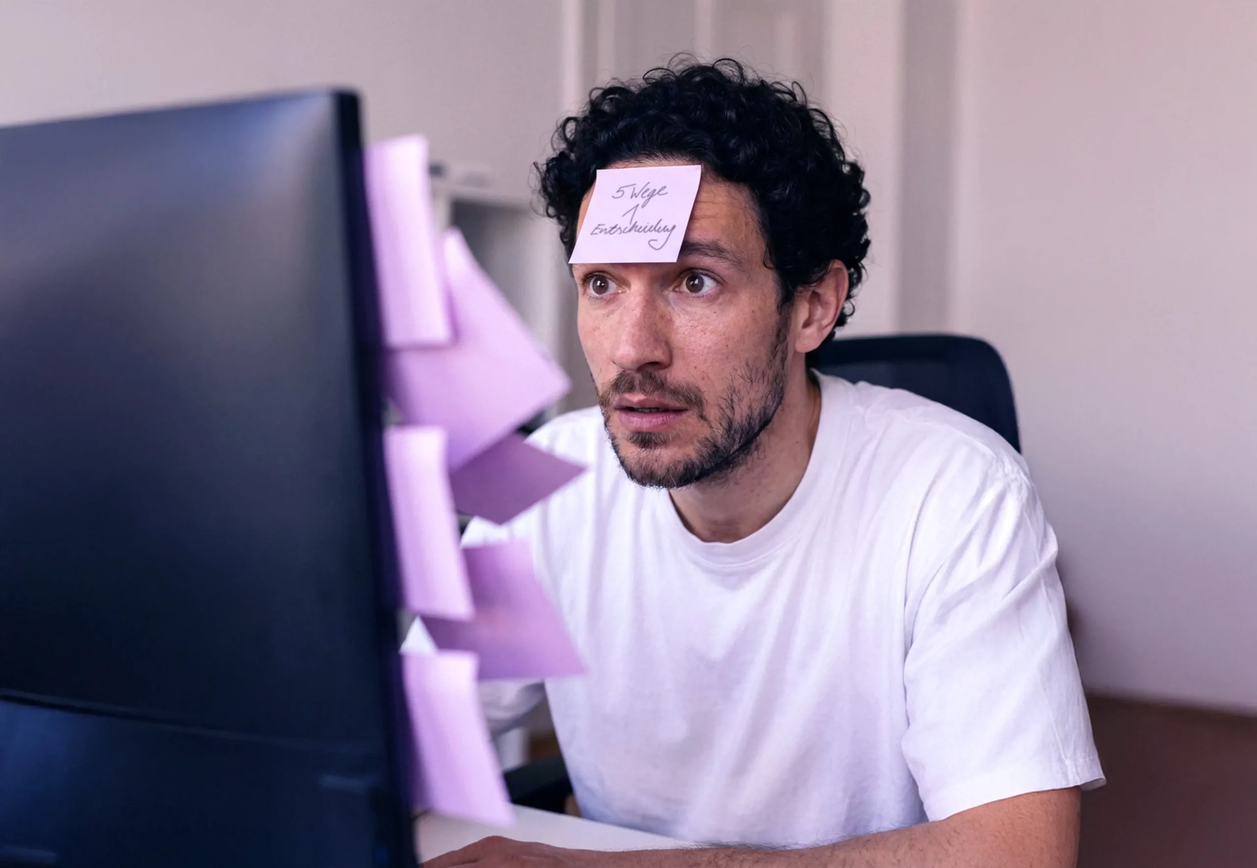 Illustrationsbild zum Artikel Durchführungswege bAV im Vergleich: Mann lehnt Stirn an Milchglaswand mit fliederfarbenen Post-its zu den Durchführungswegen der bAV.